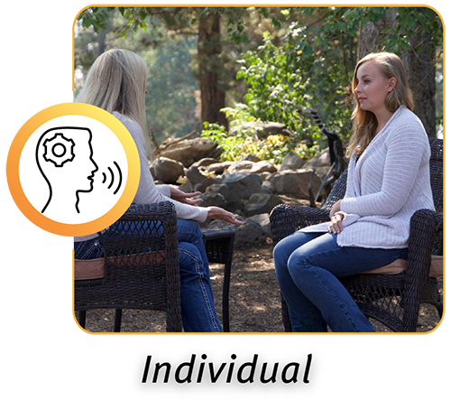 Student and a therapist in an individual therapy session outdoors at a boarding school